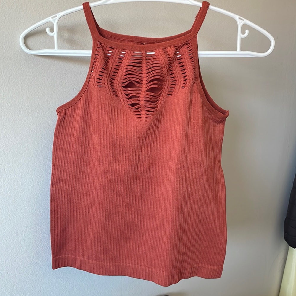 It is a tank top from Miss Valley. Color: Brown/Orange. Size: Small/Medium